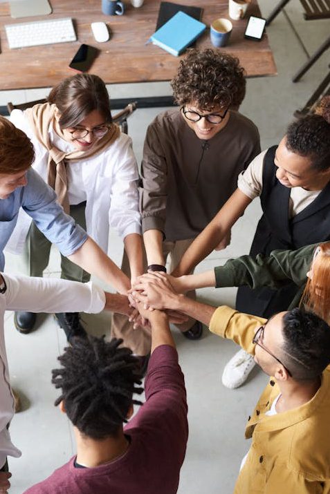 Photo Of People Holding Each Other's Hands